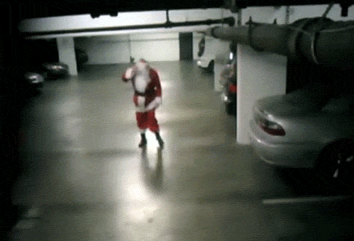 Drunk santa stumbling and hitting his head on a car