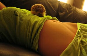 Sexy girl with hedgehog on her belly